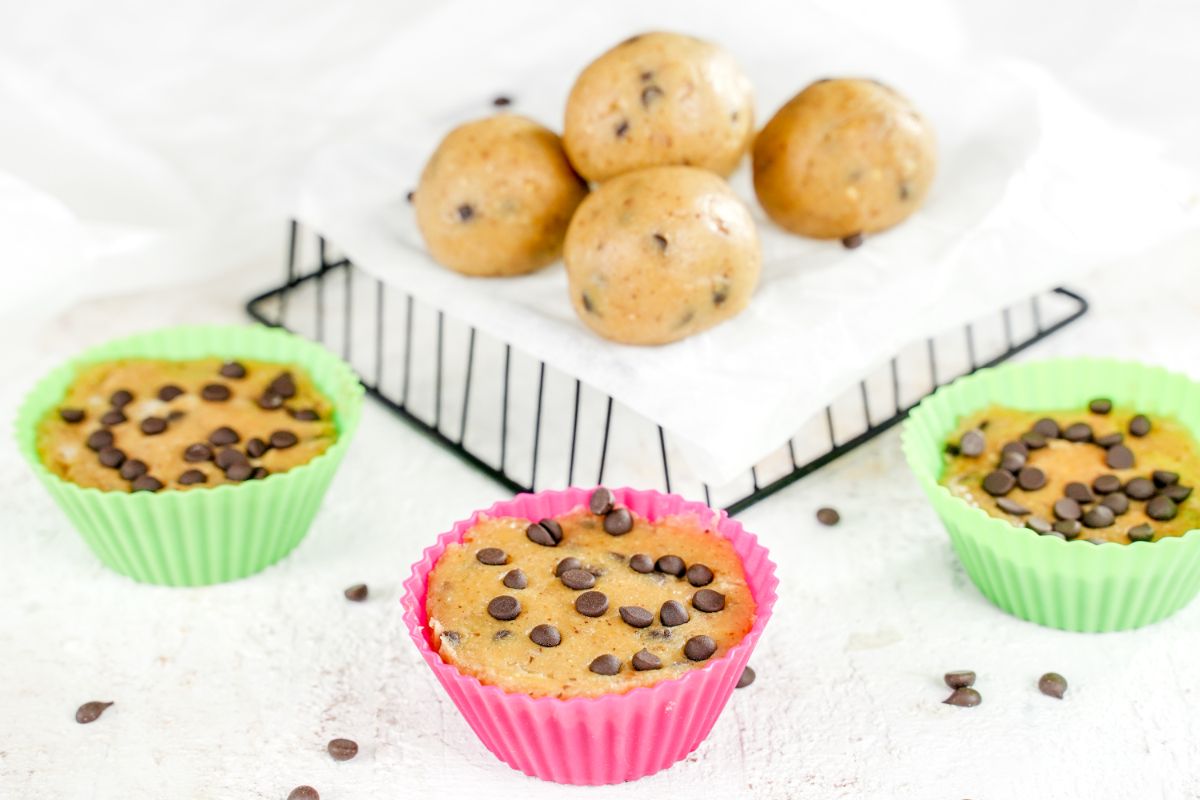 Protein-Packed No-Bake Cookie Dough on a tray with some Protein balls in muffin moulds