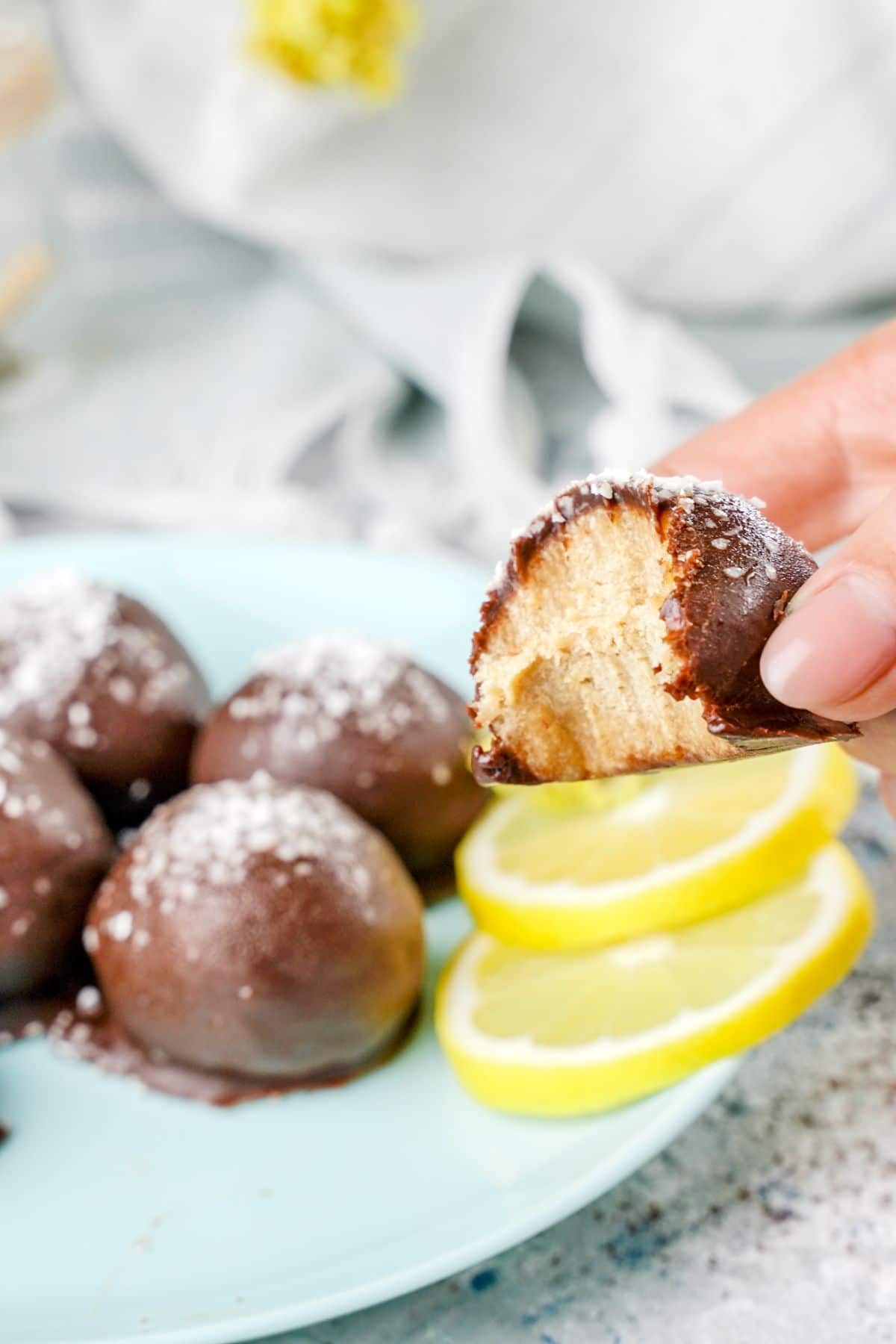 A bite of Sweet No-Bake Cookies served with lemon slices