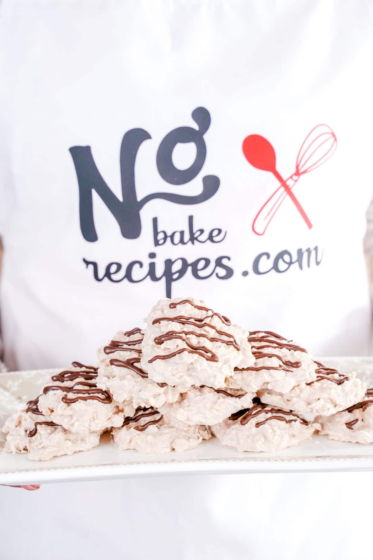 No-Bake White Chocolate Cookies served on a white plater in hand