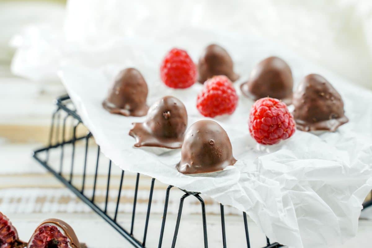 4 Ingredient Chocolate-Dipped Raspberries served on arck with some fresh raspberries