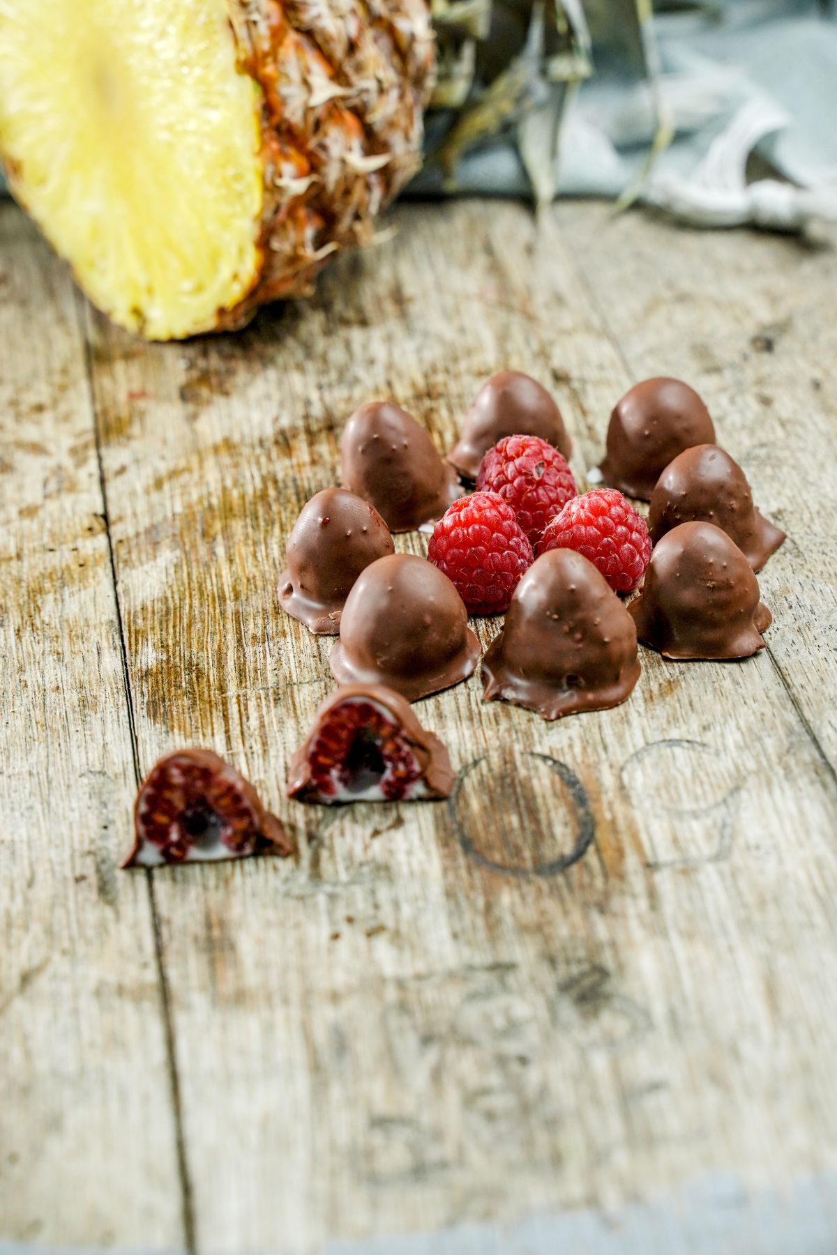 4 Ingredient Chocolate-Dipped Raspberries served on a wooden plank