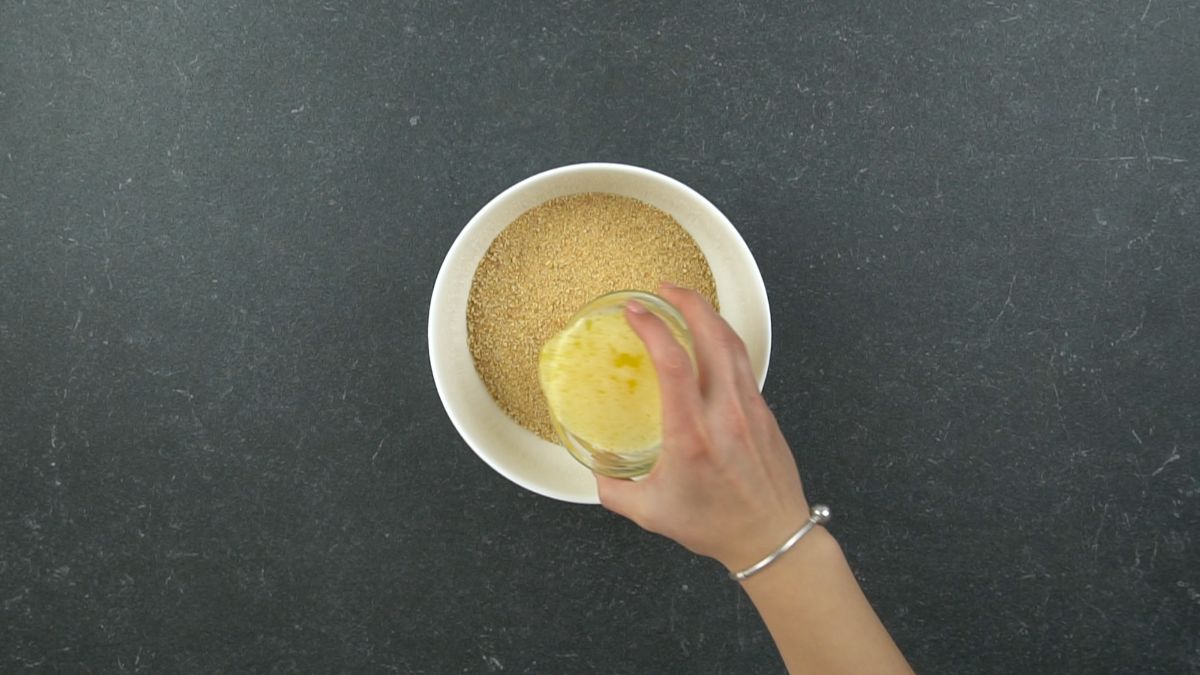 add melted butter with crumbs in a bowl