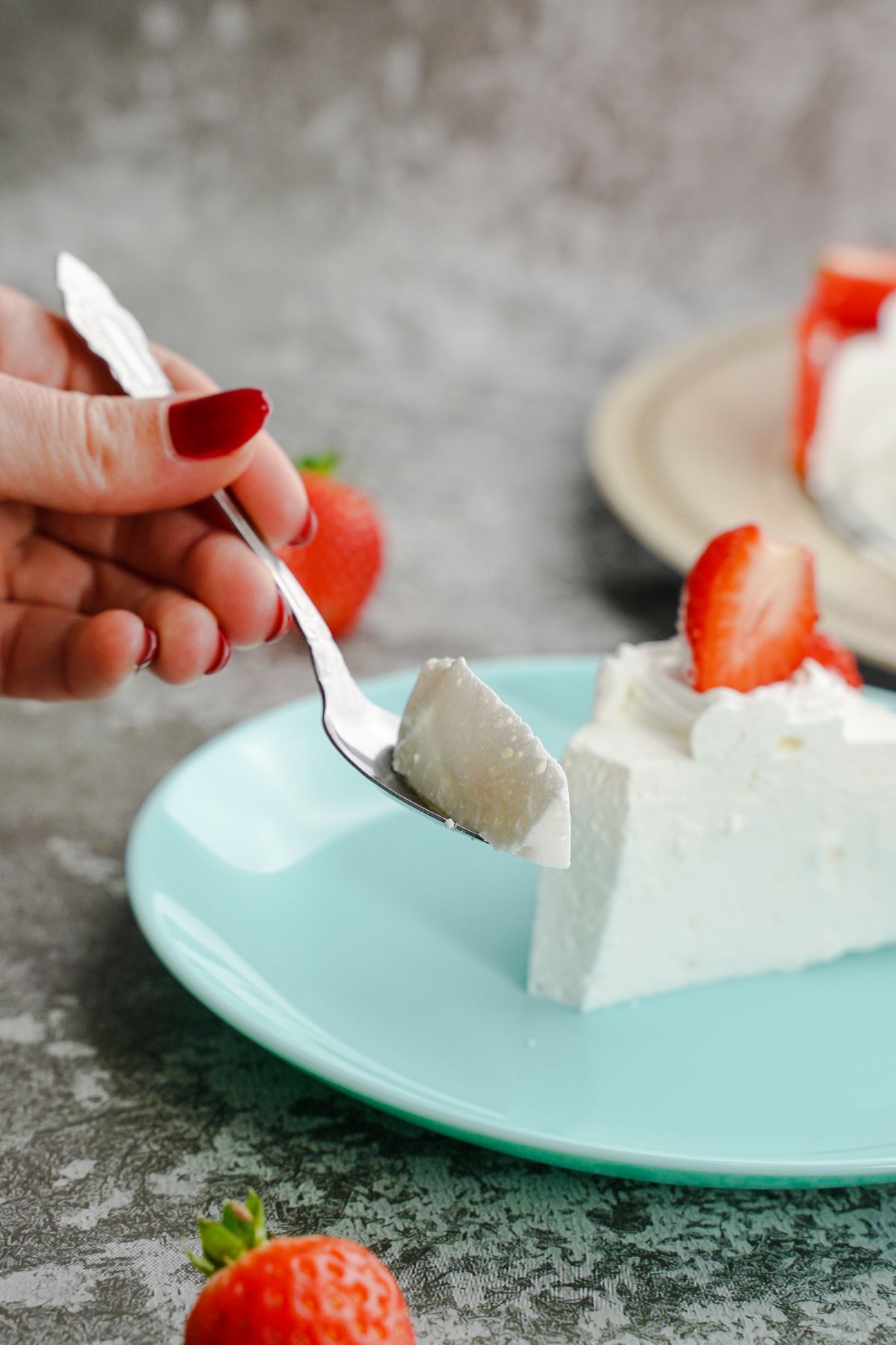 A bite of No-Bake Pavlova With Strawberries in spoon