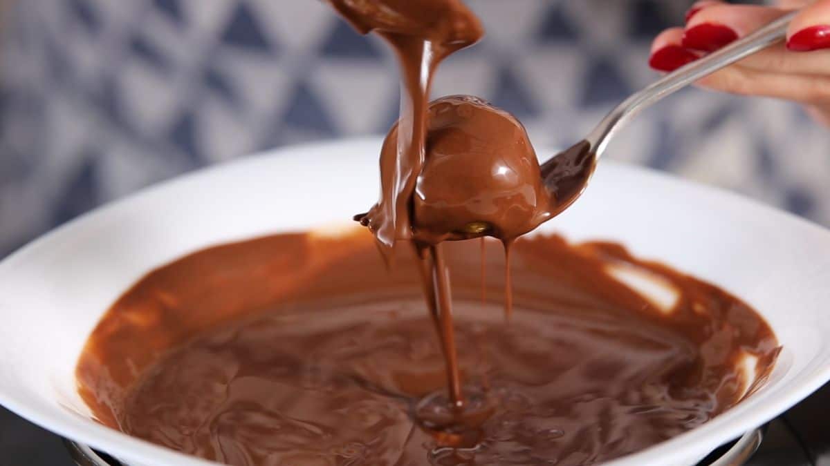 dip the balls into melted chocolate and place them on a baking paper in a bowl