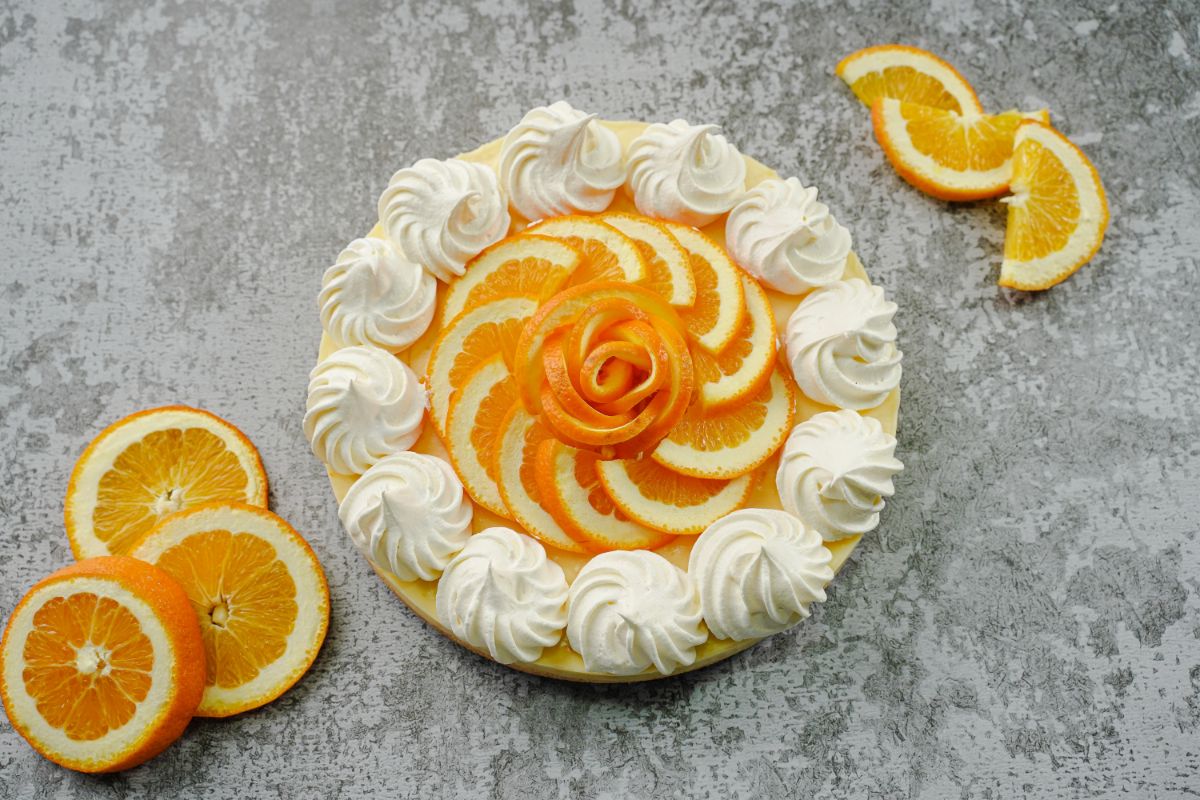 garnish No-Bake Orange Cream Pie with lemon wedges and cream