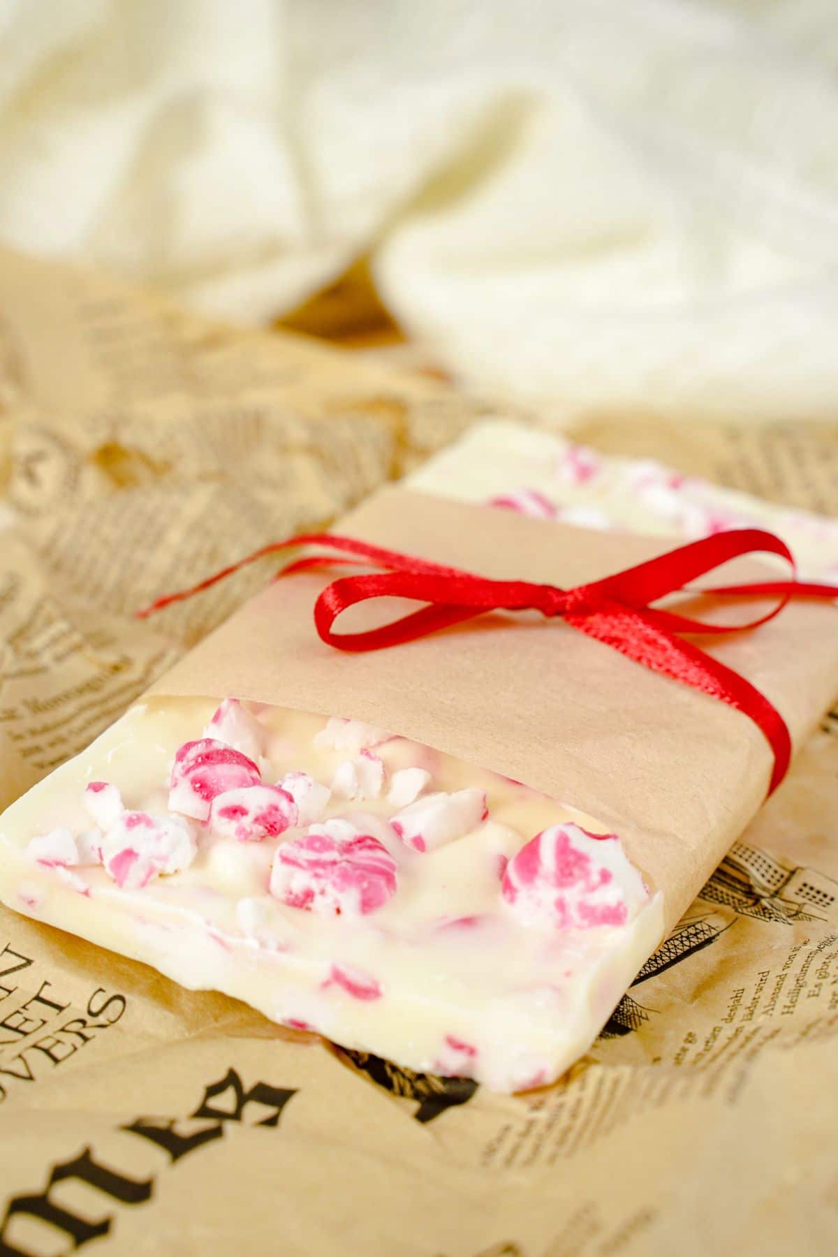 2 Ingredient Peppermint Bark decorated with red ribbon