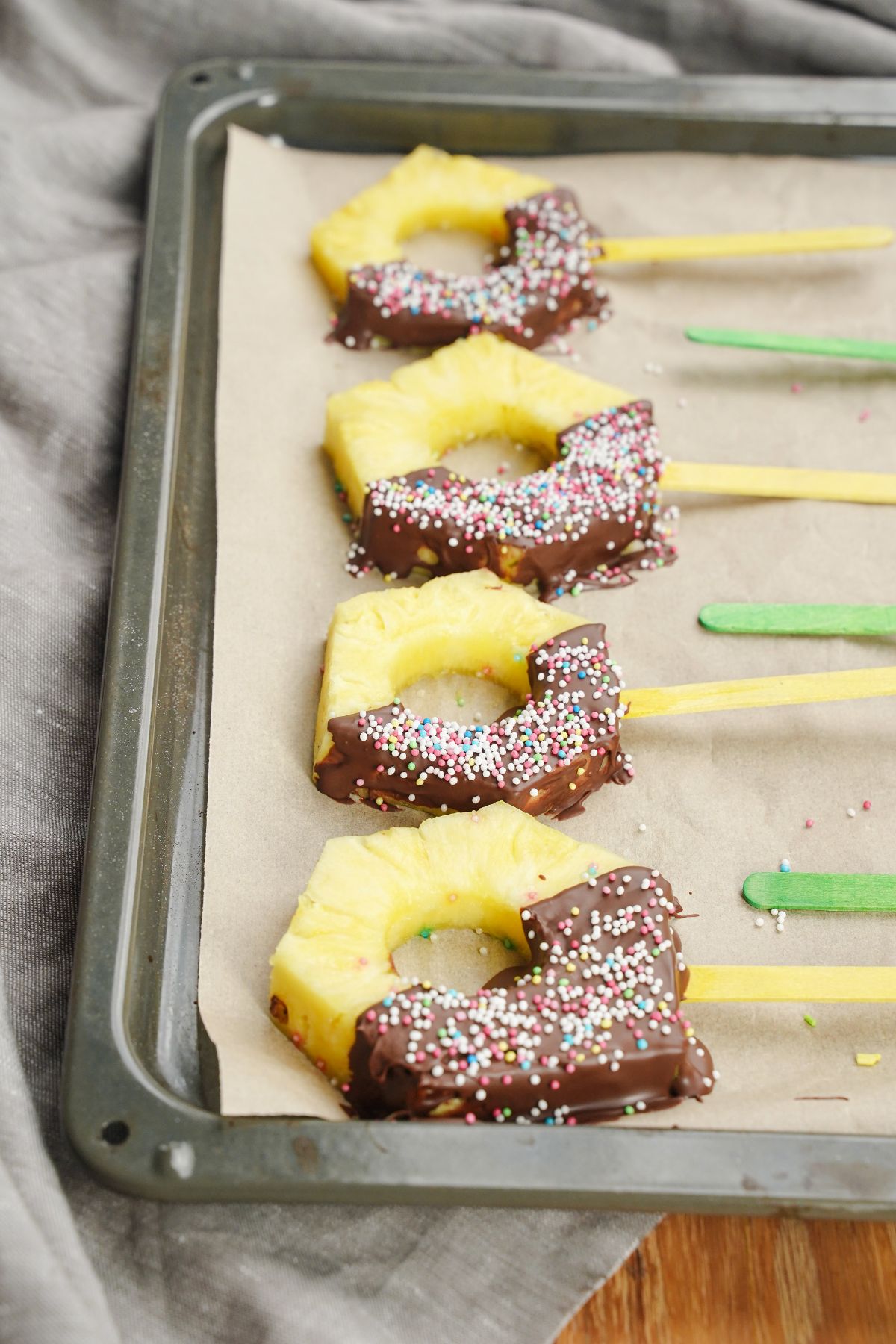 Chocolate Coated Pineapple Pops served on a plater