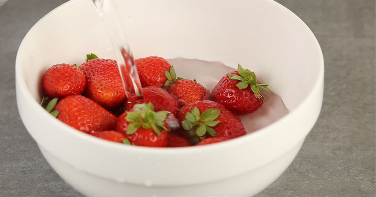 soaking strawberries in vodka to make boozy chocolate covered strawberries