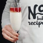person holding a champagne glass of champagne pudding