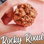 hand holding a chocolate popcorn ball with text which reads rocky road popcorn balls