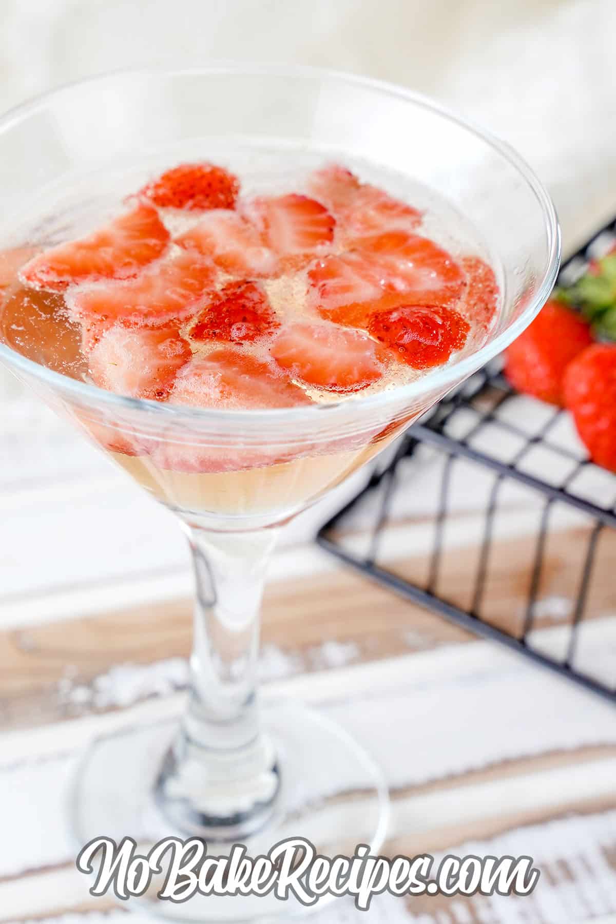 glass of champagne and strawberry champagne jello
