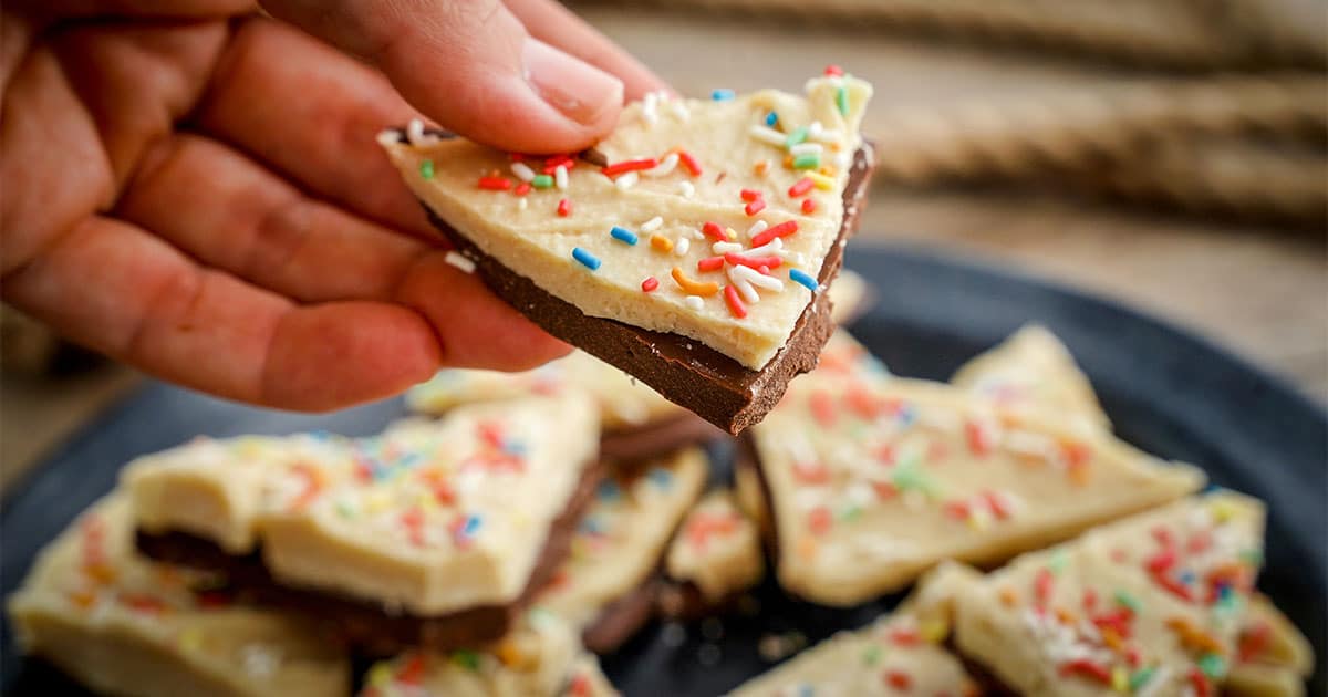 hand holding up a piece of Funfetti Bark