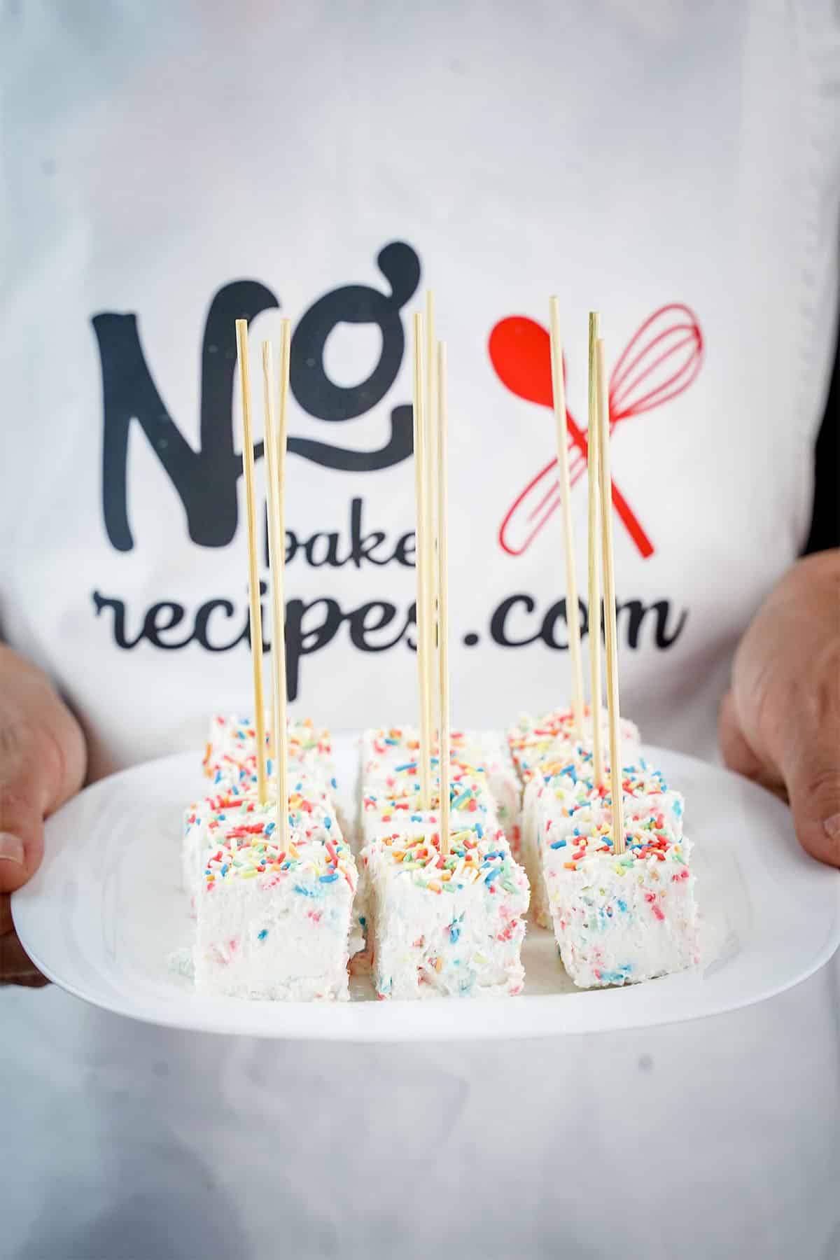 plate of Funfetti Cheesecake Pops being held by a person