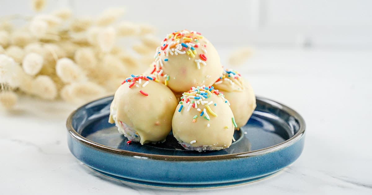 side view of a plate full of no-bake Funfetti Truffles