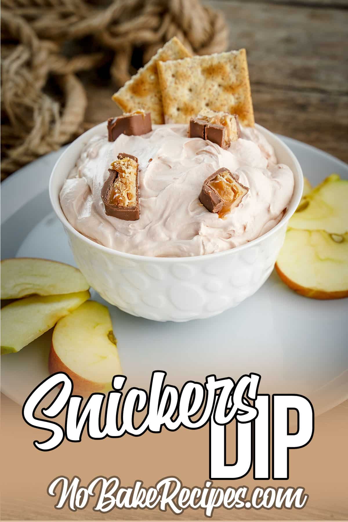a bowl of no-bake dessert dip with text which reads Snickers dip