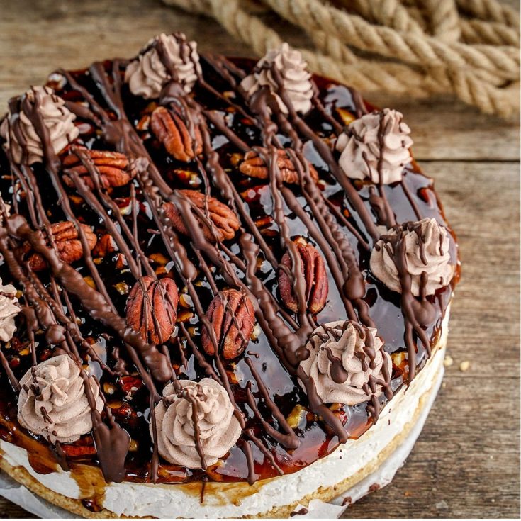 overhead view of no-bake cheesecake with pecan and caramel topping