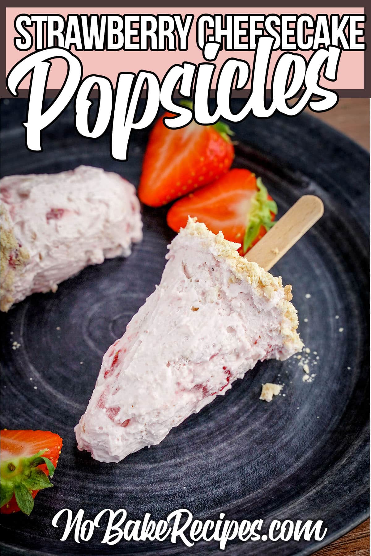 cheesecake and strawberry popsicles laying on a plate with text which reads strawberry cheesecake popsicles