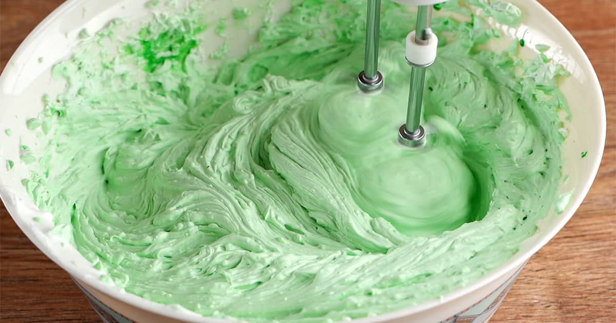 ingredients being mixed to make no-bake Andes Mint Cheesecake