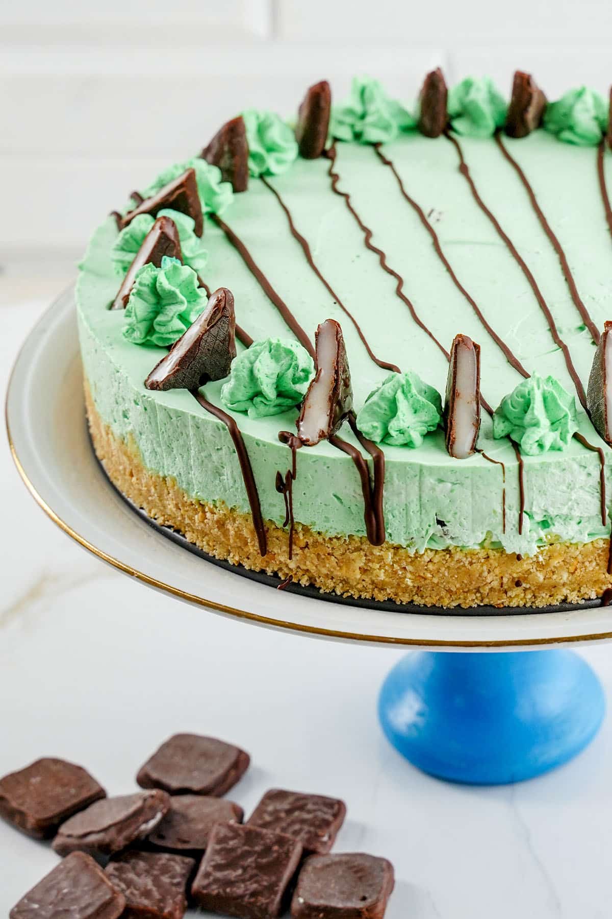 no-bake Andes Mint Cheesecake on a cake pedastal