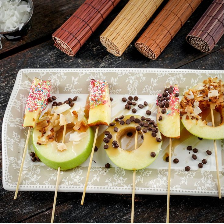 caramel apple slices laid out on a plate