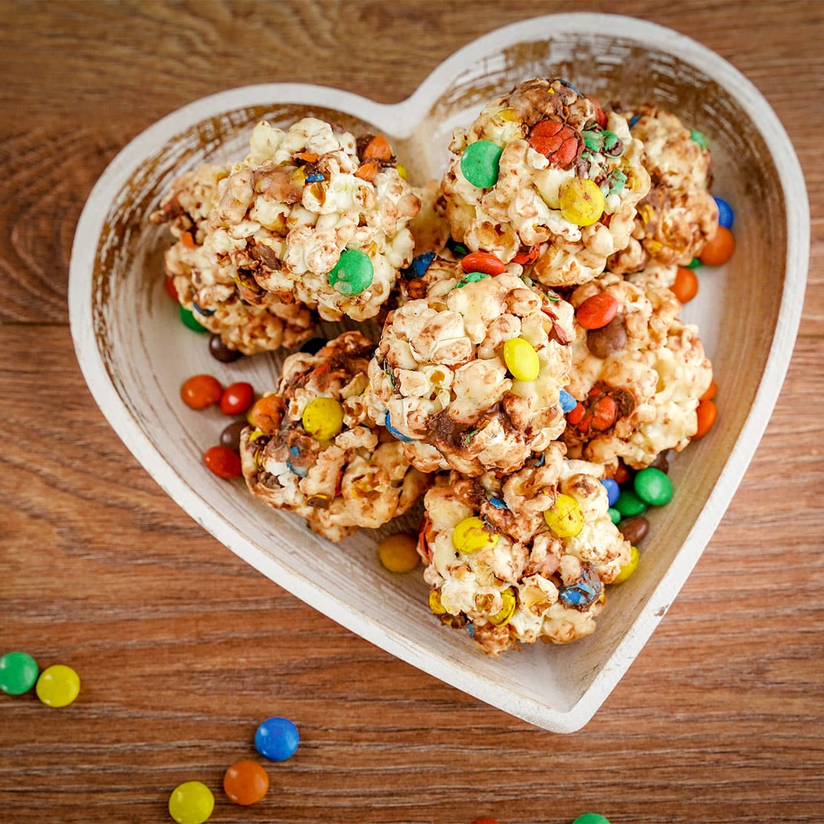 overhead view of heart-shaped plate full of popcorn balls