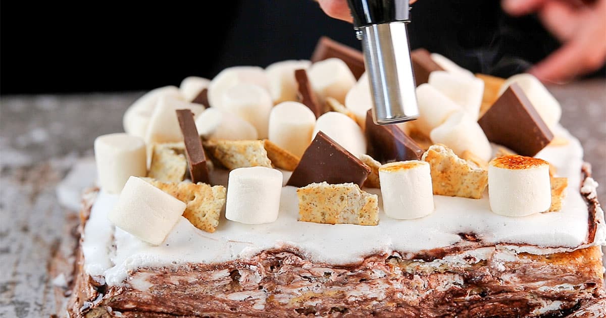 toasting marshmallows to make s'mores ice box cake