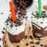 close up of two mint chocolate chip popsicles.