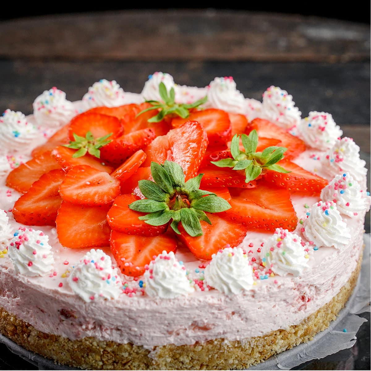 Sliced Strawberries on top of Strawberry Cheesecake.