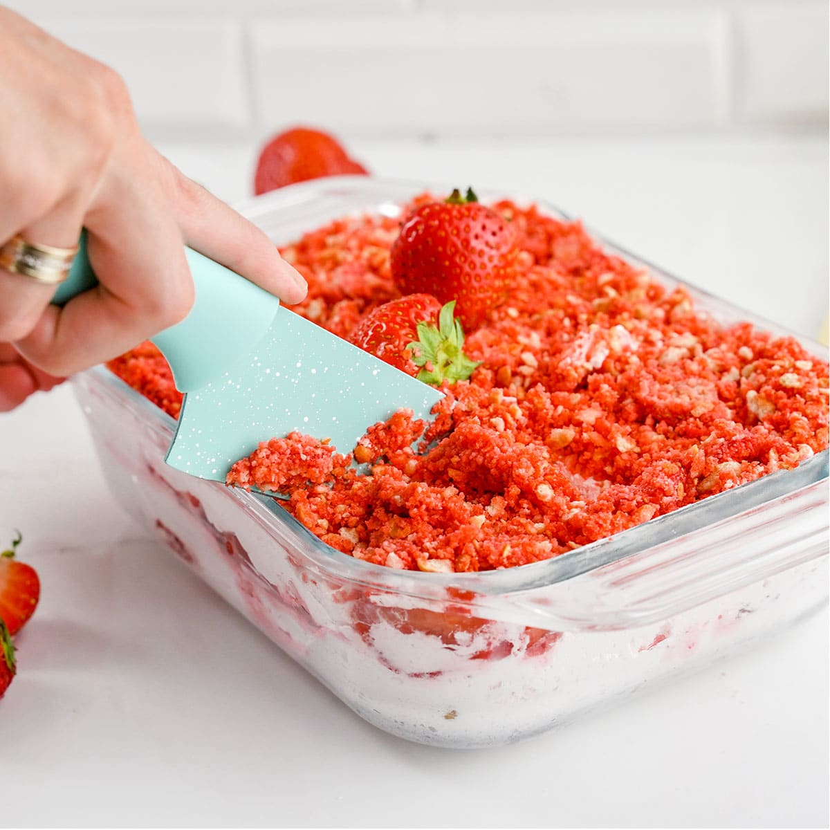 Slicing of the Strawberry Crumble Icebox cake.