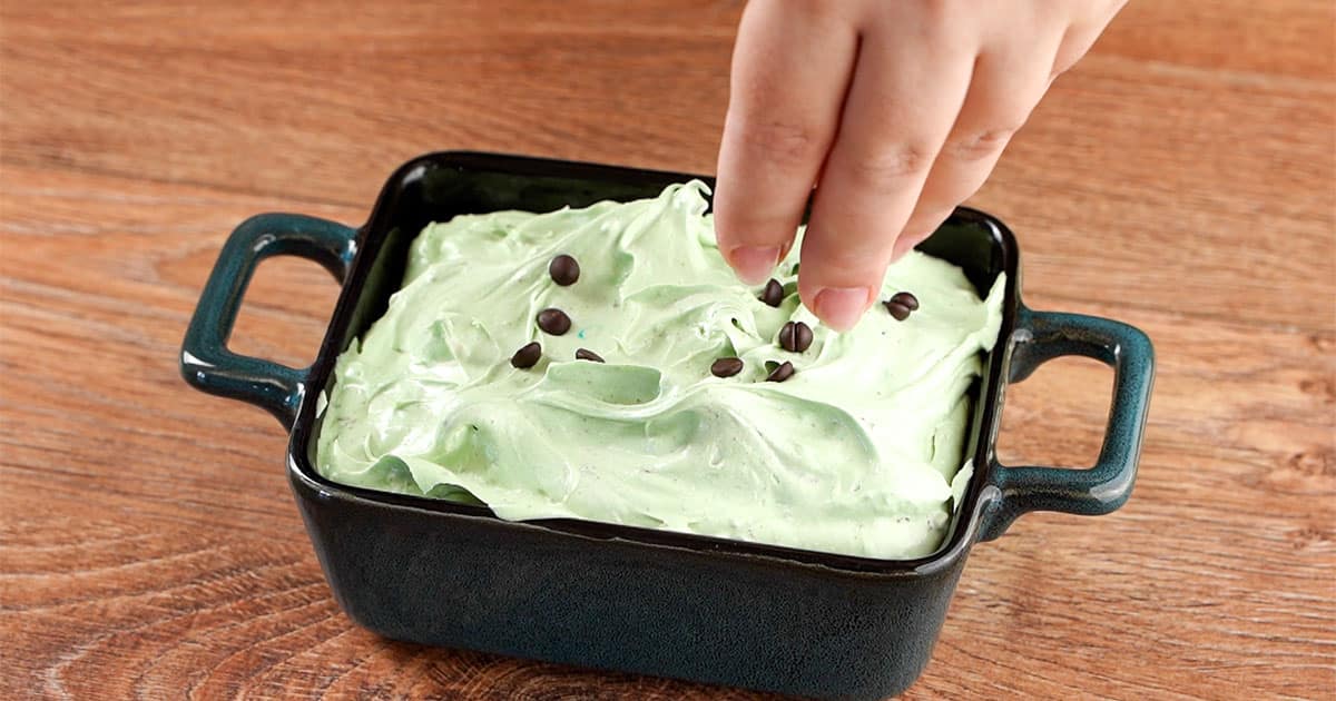 sprinkle mini chocolate chips on top of Thin Mint Cheesecake dip.