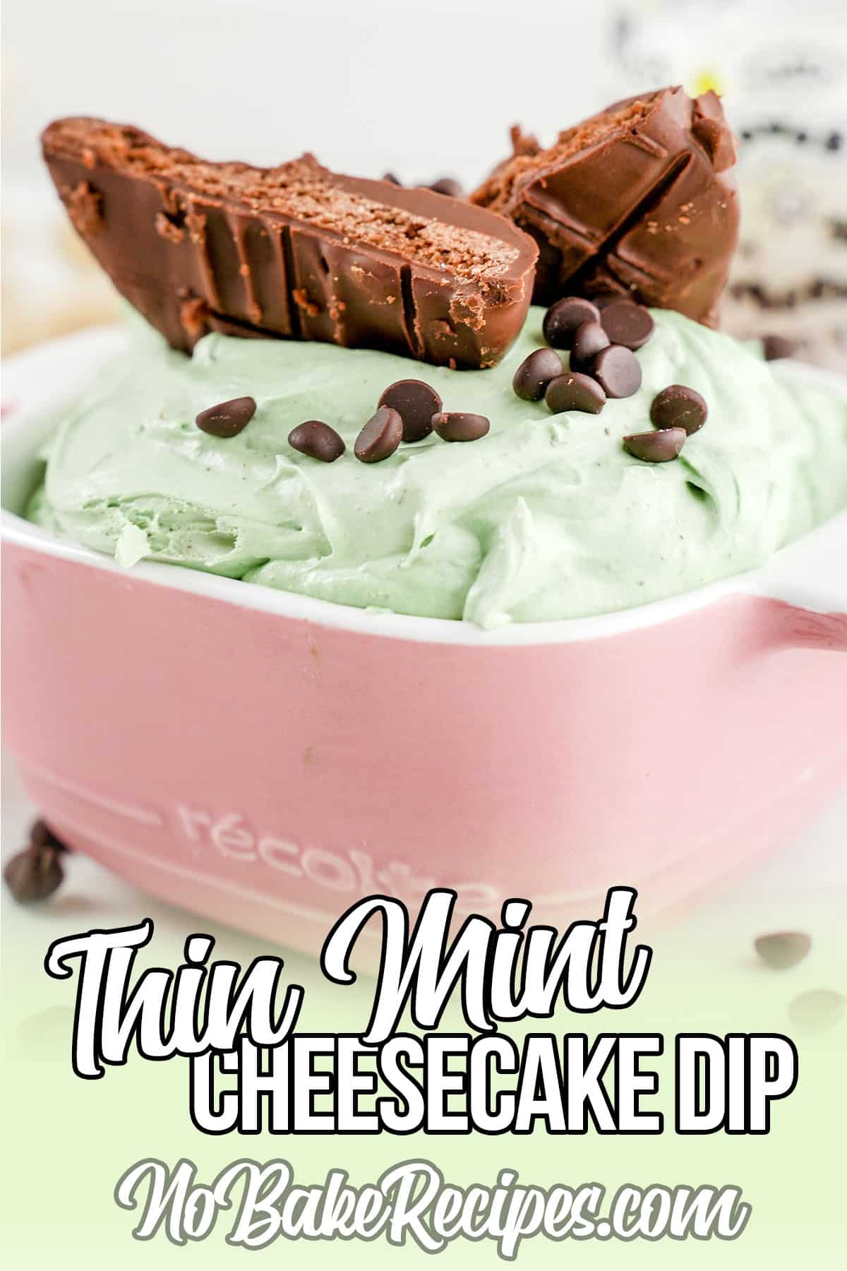 side view of cookies on top of Thin Mint Cheesecake Dip in pink dish.